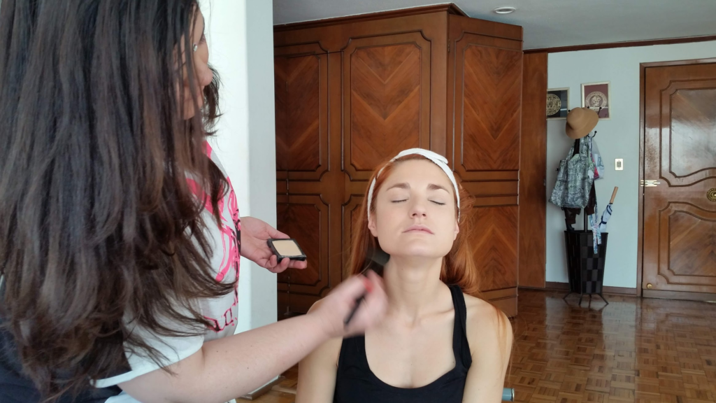 Paty having her make-up done between custome changes